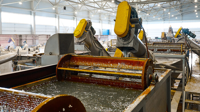 Exhaust air from a compressor heats the water for hot water applications in parts cleaning.